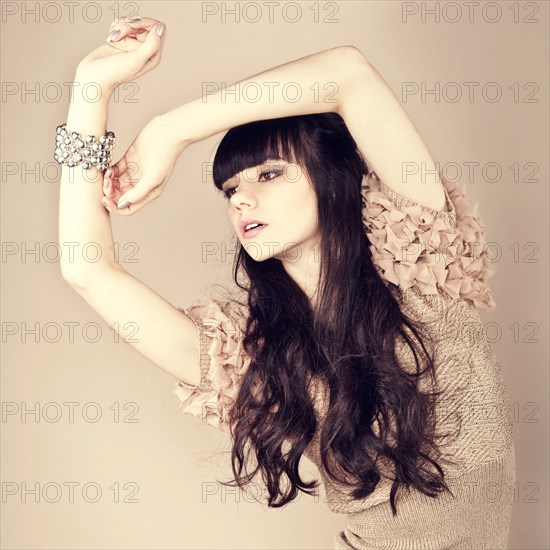 Pensive Caucasian woman wearing ruffled sweater