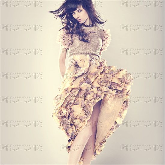 Caucasian woman wearing ruffled skirt dancing