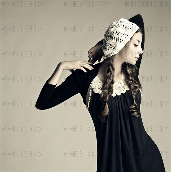 Caucasian girl wearing traditional dress and hat