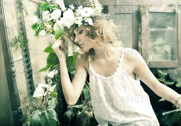 Pensive Caucasian woman sitting in garden