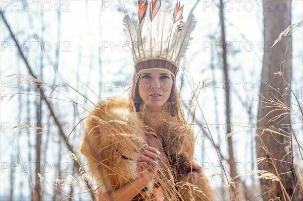 Caucasian woman wearing headdress in forest