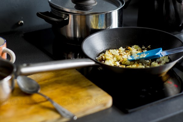 Onions cooking in pan on stove