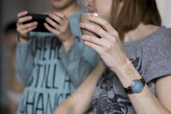 Caucasian mother watching son using cell phone