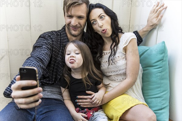 Family taking selfie with cell phone