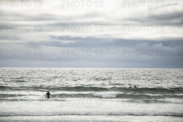 Surfers in ocean waves