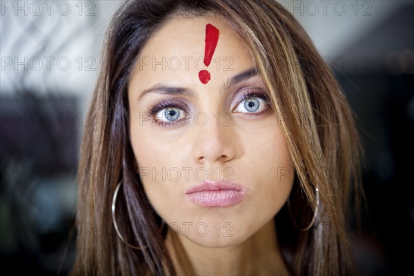 Hispanic woman with exclamation mark on her forehead