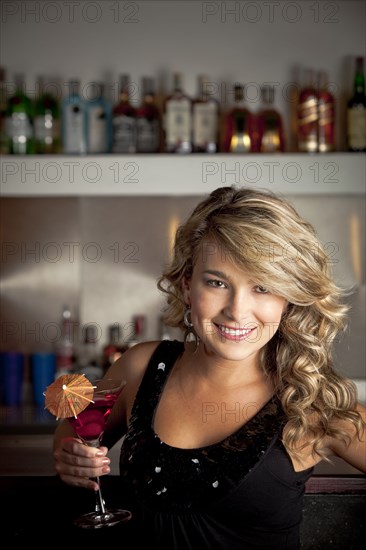 Hispanic woman drinking martini