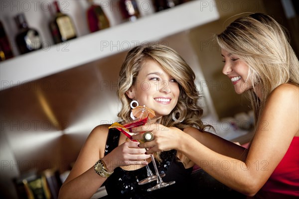 Hispanic friends toasting with martinis