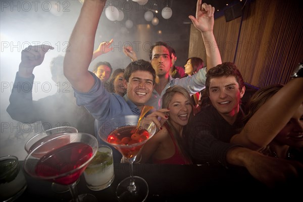 Hispanic friends dancing in nightclub