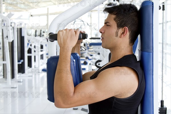 Hispanic man working out in health club