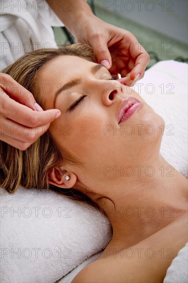 Hispanic woman having facial