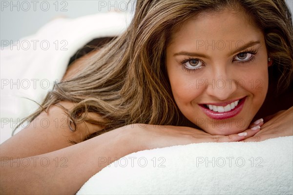 Hispanic woman laying on massage table