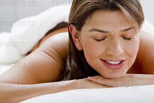 Hispanic woman laying on massage table