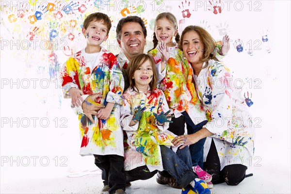 Hispanic family covered in paint