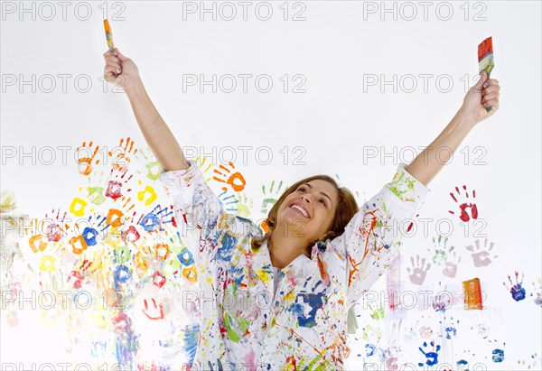 Messy Hispanic woman covered in paint