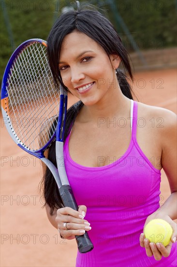 Hispanic woman playing tennis