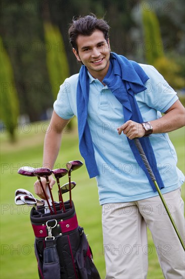 Hispanic man playing golf