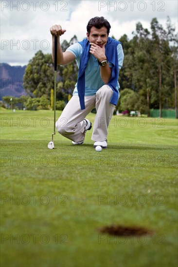 Hispanic man assessing golf course