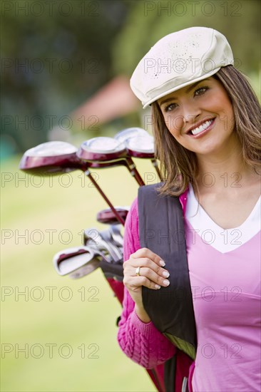 Hispanic woman playing golf