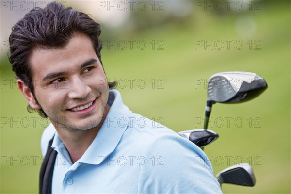 Hispanic man playing golf