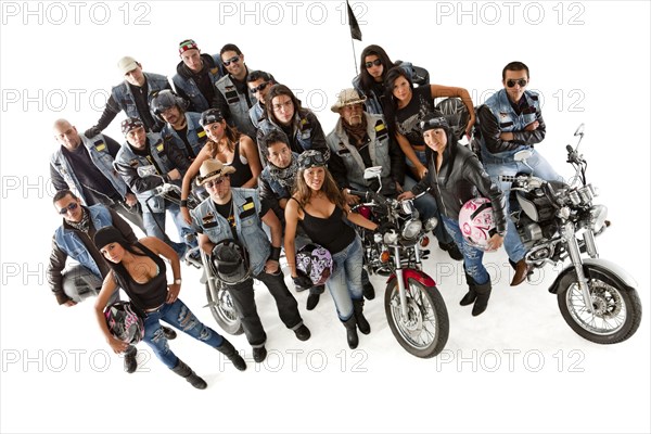 Hispanic bikers standing with motorcycles