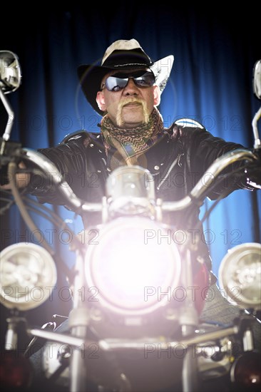 Hispanic biker sitting on motorcycle