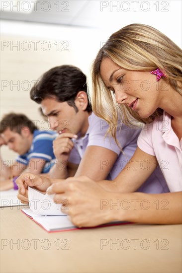 Hispanic college students studying in classroom