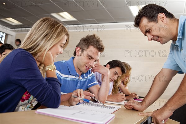 Teacher helping Hispanic college students