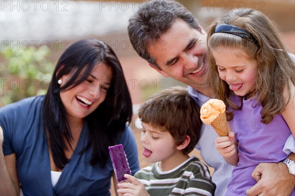 Hispanic family enjoying ice cream together