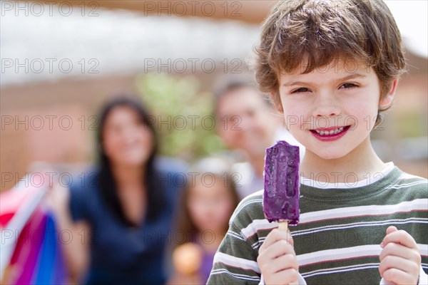 Hispanic boy eating popsicle