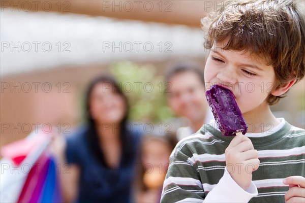 Hispanic boy eating popsicle