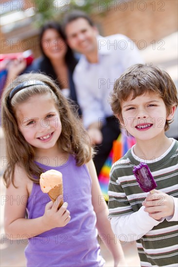 Hispanic brother and sister eating ice cream