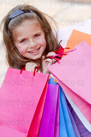 Hispanic girl carrying shopping bags