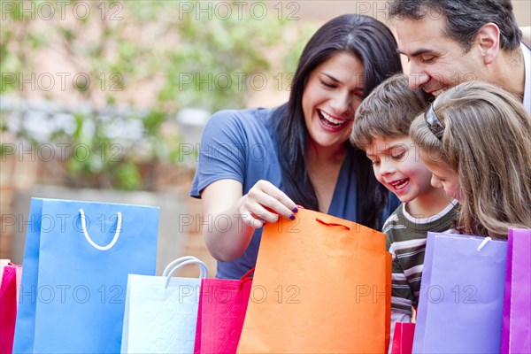 Hispanic family looking into shopping bags