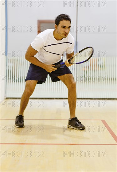 Hispanic man playing squash