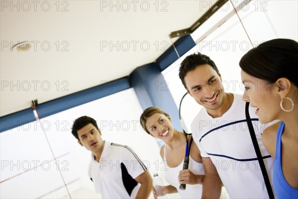 Hispanic couples on squash court