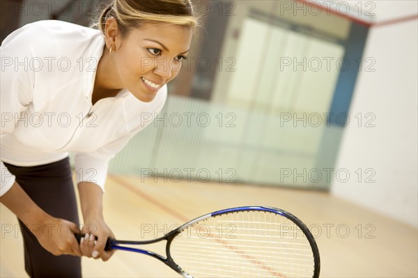 Hispanic woman playing squash