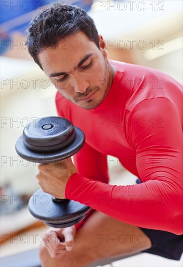 Hispanic woman smiling in gym