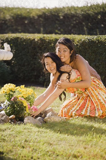 Chinese daughter hugging mother in garden