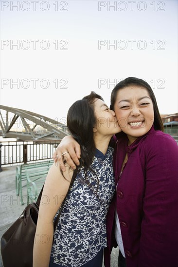 Chinese mother kissing daughter
