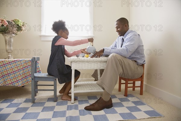 African father and daughter playing tea