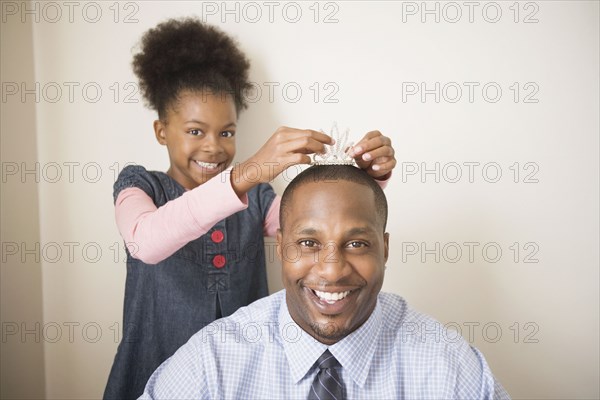 African father wearing daughter's tiara