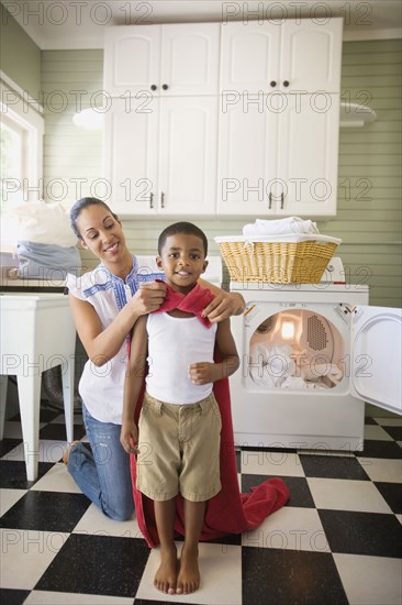 Mixed race mother tying towel to son