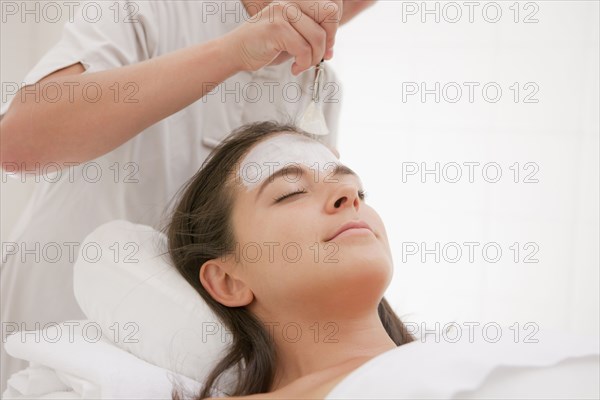 Woman having facial spa treatment