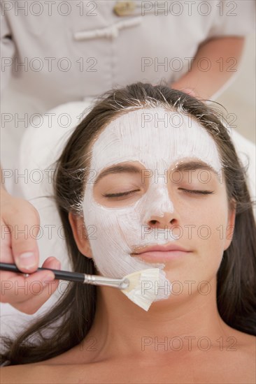 Woman having facial spa treatment