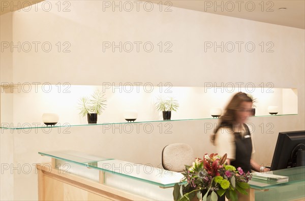 Woman working at spa resort desk