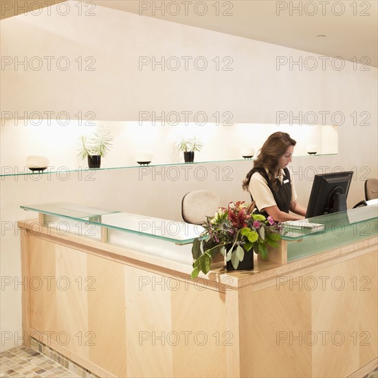 Woman working at spa resort desk