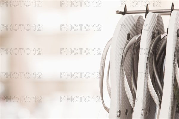 Close up of flip flops hanging on rack