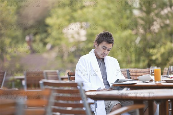 Man enjoying breakfast on outdoor patio