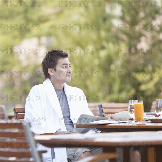 Man enjoying breakfast on outdoor patio